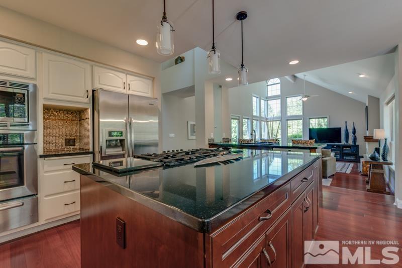 4275 Bitteroot Road Reno, NV 89519 - Photo 10 of 39 a kitchen with counter top space appliances and a ceiling fan