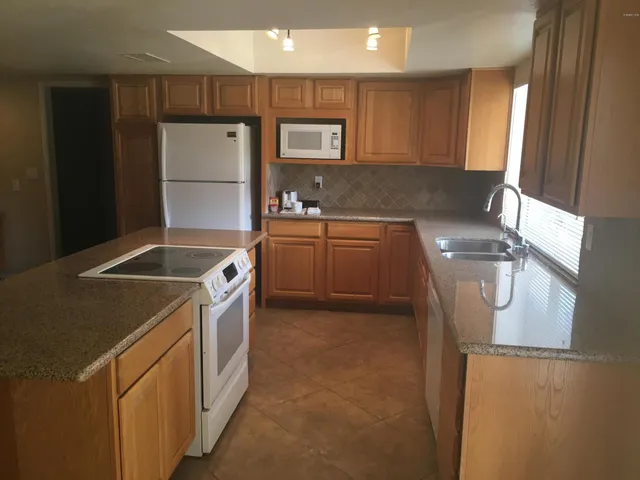a kitchen with a sink a refrigerator and a stove