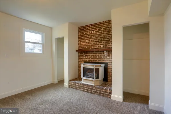 a view of an empty room with a fireplace