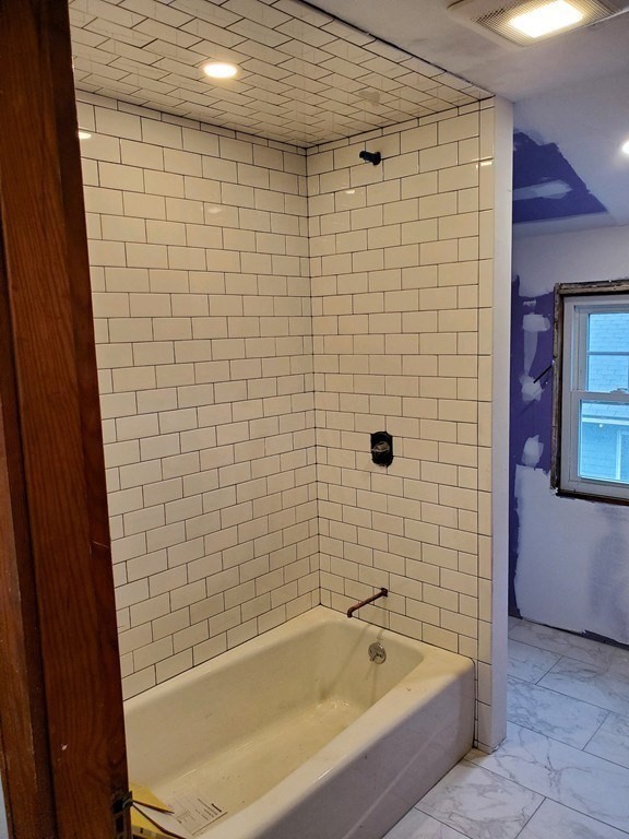22 Allen Street, Unit 2 Arlington, MA 02474 - Photo 16 of 25 a bathroom with a bathtub and shower