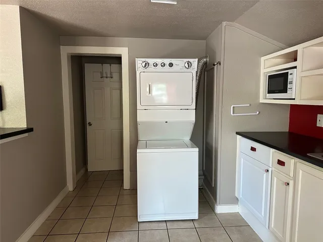 a kitchen with a refrigerator sink and cabinets