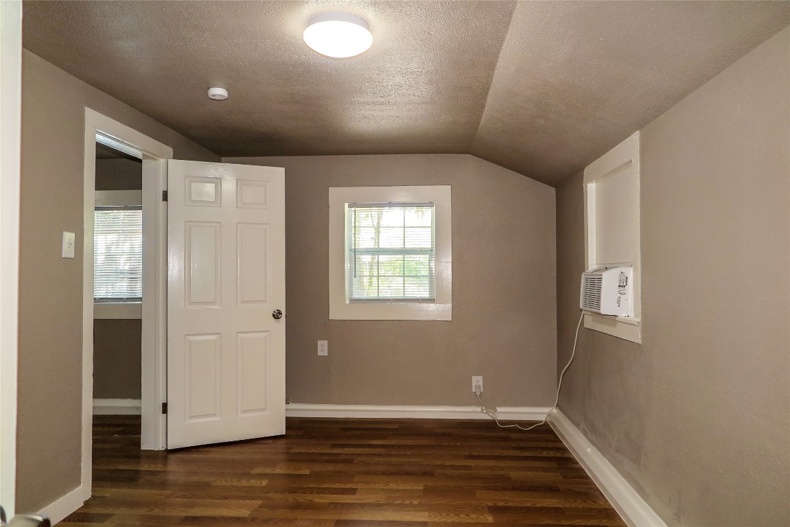 1312 A Pine Street, Unit A Georgetown, TX 78626 - Photo 15 of 26 a view of an empty room with wooden floor and a window
