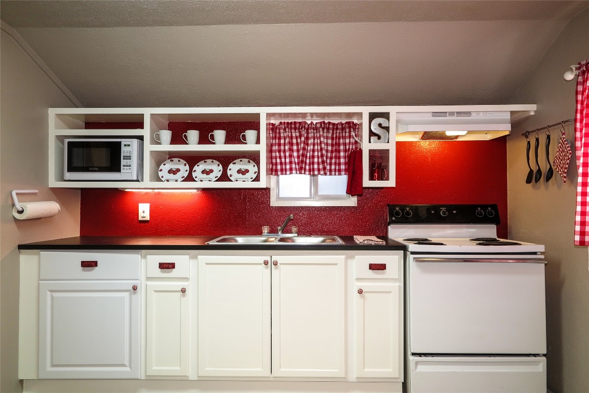 1312 A Pine Street, Unit A Georgetown, TX 78626 - Photo 10 of 26 a cabinet with flat screen tv and cabinets