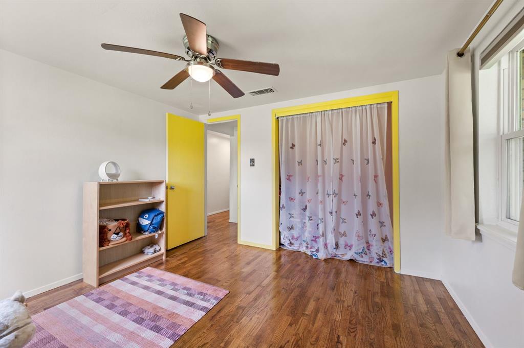 3900 Moseley Road Cross Roads, TX 76227 - Photo 15 of 36 Spacious room with wood-finish flooring, white walls, and a ceiling fan with integrated lighting