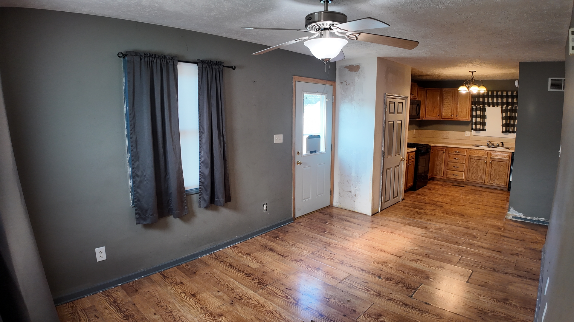 601 East Webster Street Clinton, IL 61727 - Photo 6 of 21 wooden floor in an empty room with a kitchen