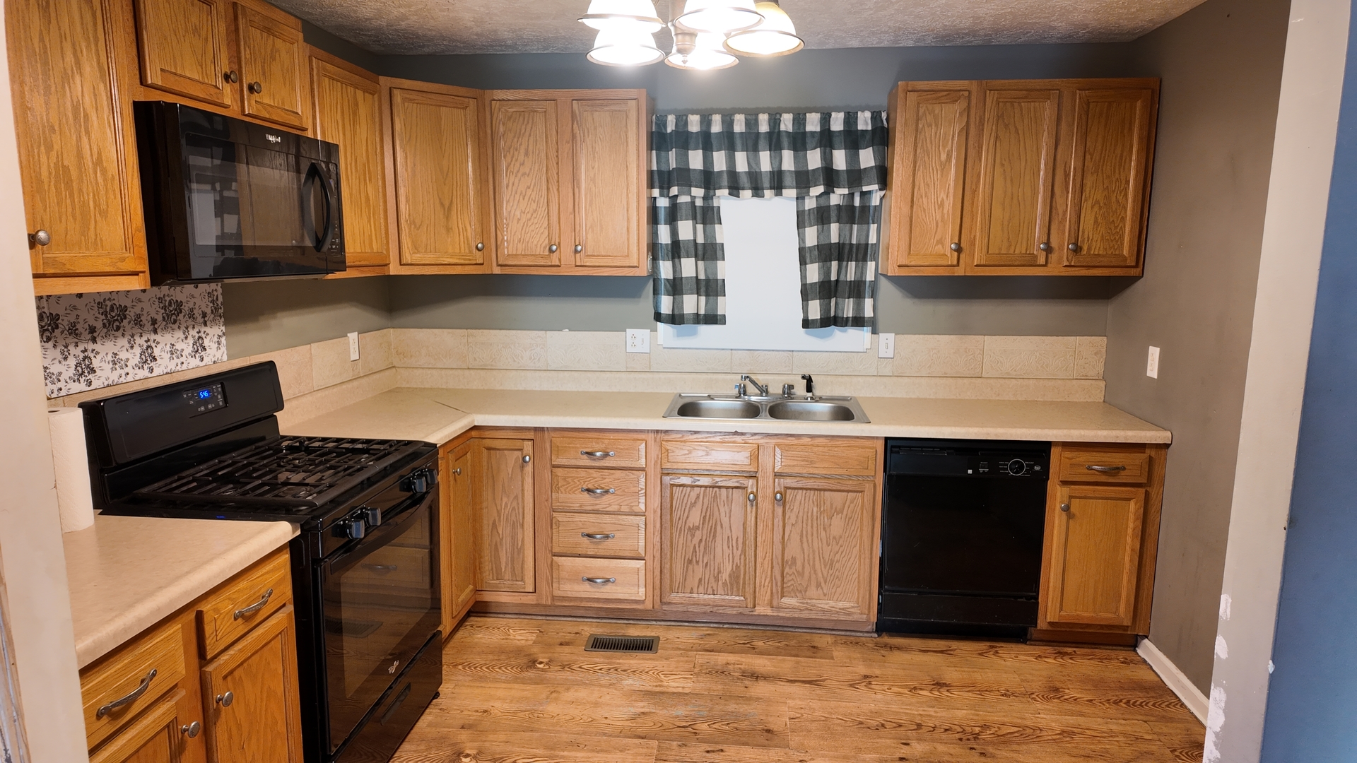 601 East Webster Street Clinton, IL 61727 - Photo 8 of 21 a kitchen with stainless steel appliances granite countertop a stove a sink and a microwave