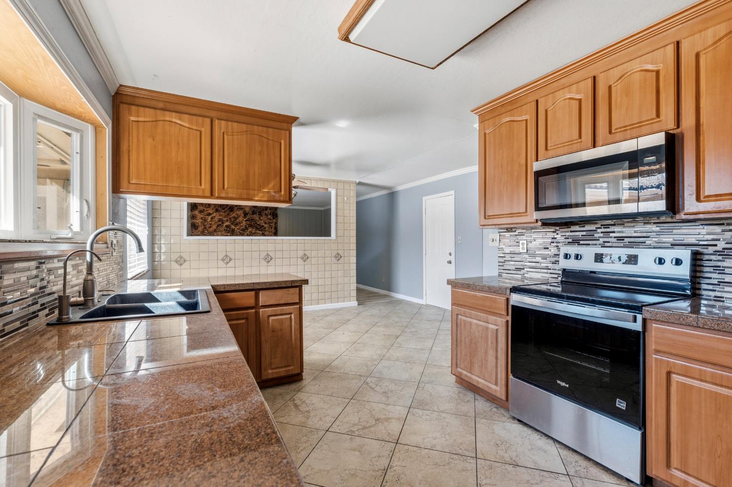 17500 Von Sosten Road Tracy, CA 95304 - Photo 16 of 50 a kitchen with stainless steel appliances granite countertop a stove microwave and sink