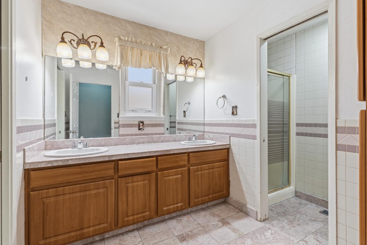 17500 Von Sosten Road Tracy, CA 95304 - Photo 22 of 50 a bathroom with a double vanity sink and a mirror