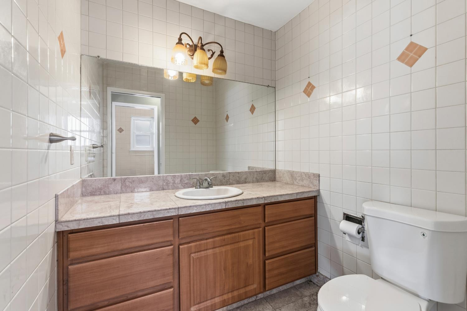 17500 Von Sosten Road Tracy, CA 95304 - Photo 30 of 50 a bathroom with a granite countertop toilet sink and mirror