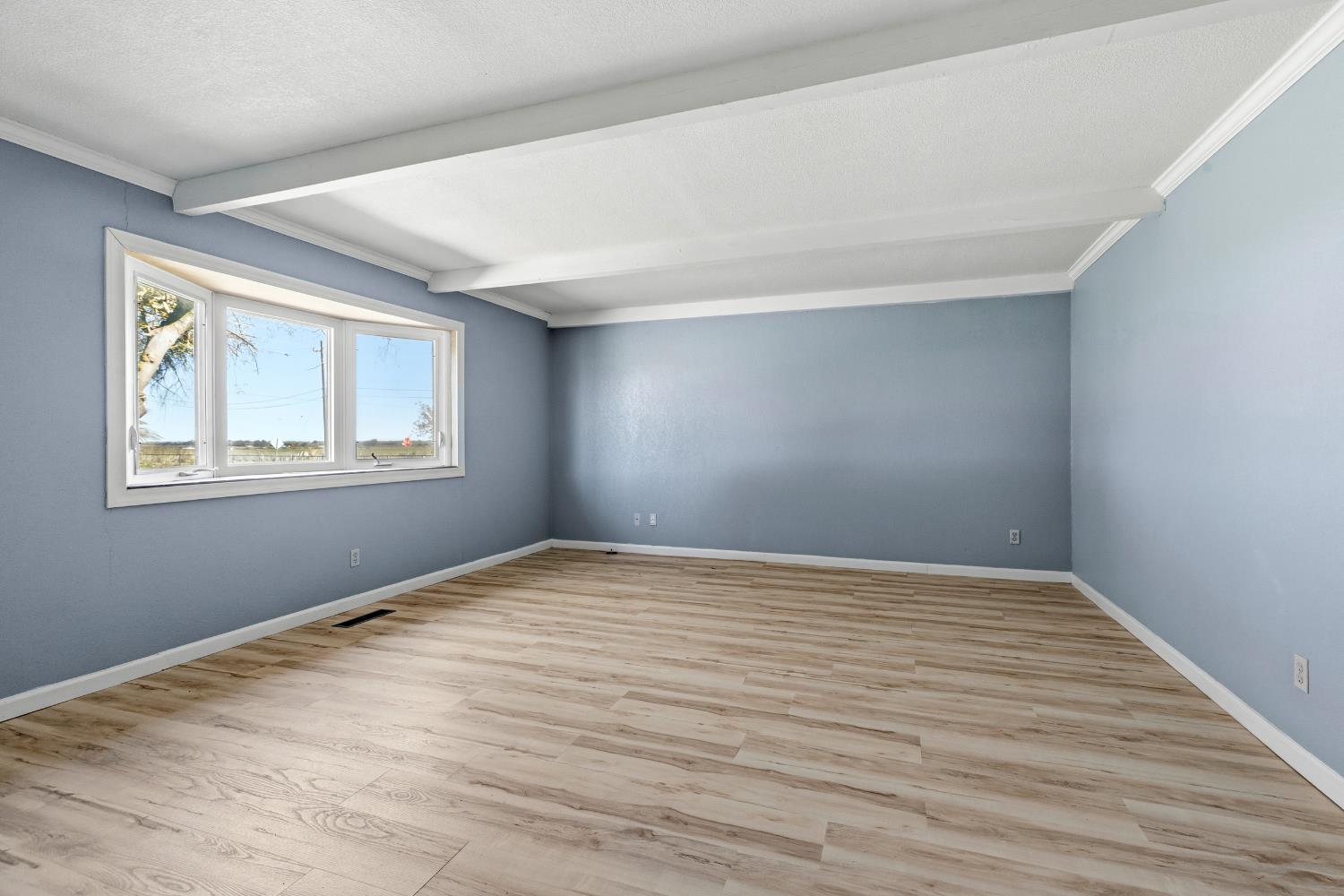 17500 Von Sosten Road Tracy, CA 95304 - Photo 7 of 50 a view of an empty room with wooden floor and a window