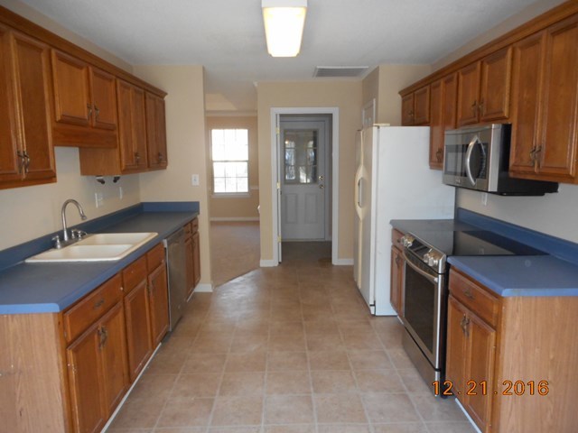 979 Old Cabaniss Road Forsyth, GA 31029 - Photo 12 of 33 a kitchen with a sink stove and refrigerator
