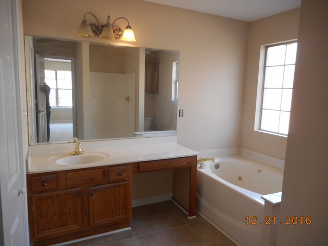 979 Old Cabaniss Road Forsyth, GA 31029 - Photo 15 of 33 a bathroom with a tub a sink and mirror