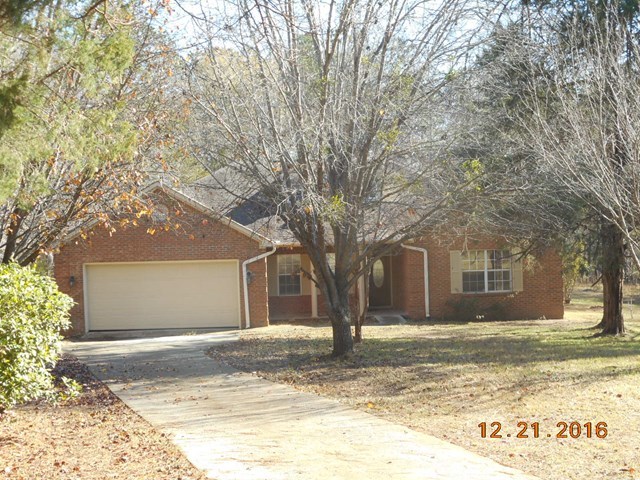 979 Old Cabaniss Road Forsyth, GA 31029 - Photo 4 of 33 a front view of a house with a yard covered in snow