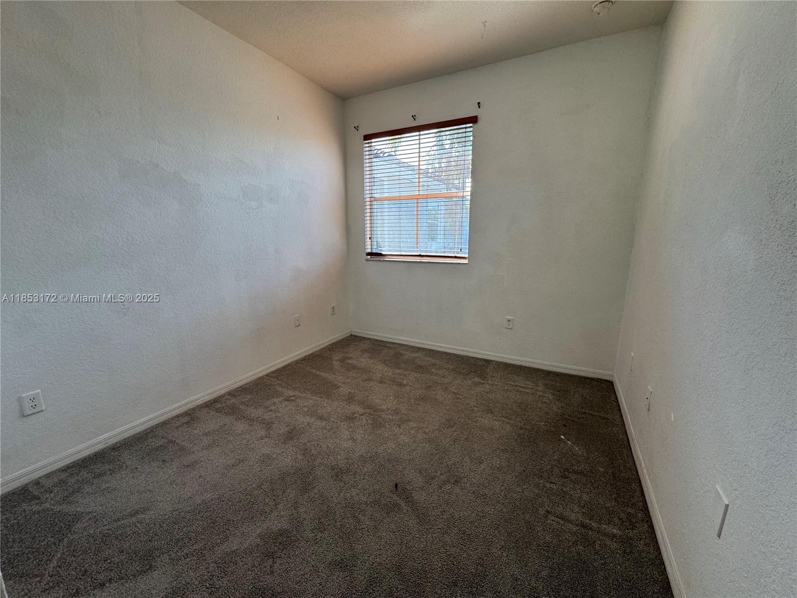 14046 Southwest 49th Street, Unit 16 Miramar, FL 33027 - Photo 14 of 22 an empty room with a window