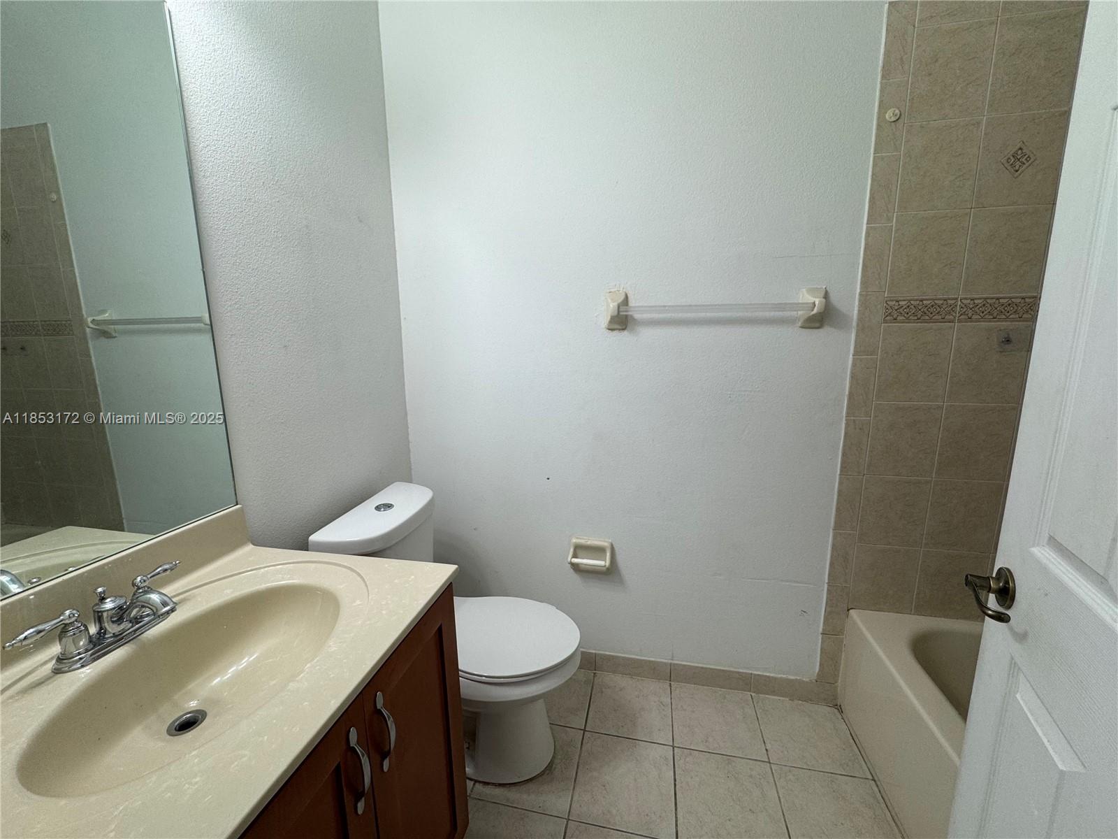 14046 Southwest 49th Street, Unit 16 Miramar, FL 33027 - Photo 15 of 22 a bathroom with a sink toilet and shower