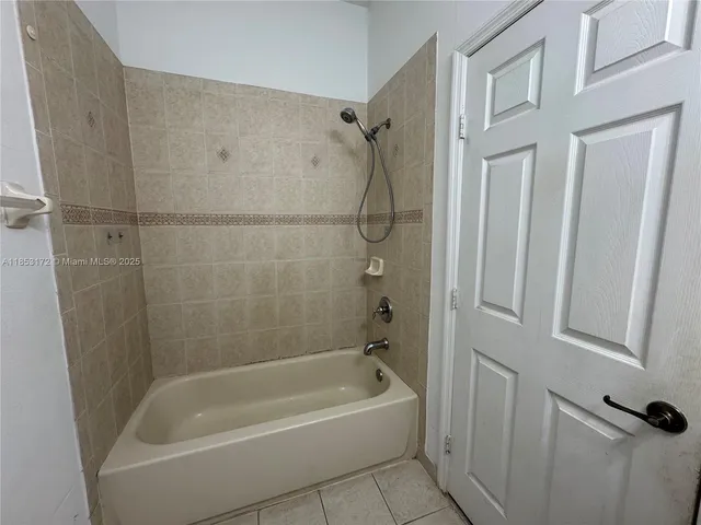 a view of a workspace with furniture and window