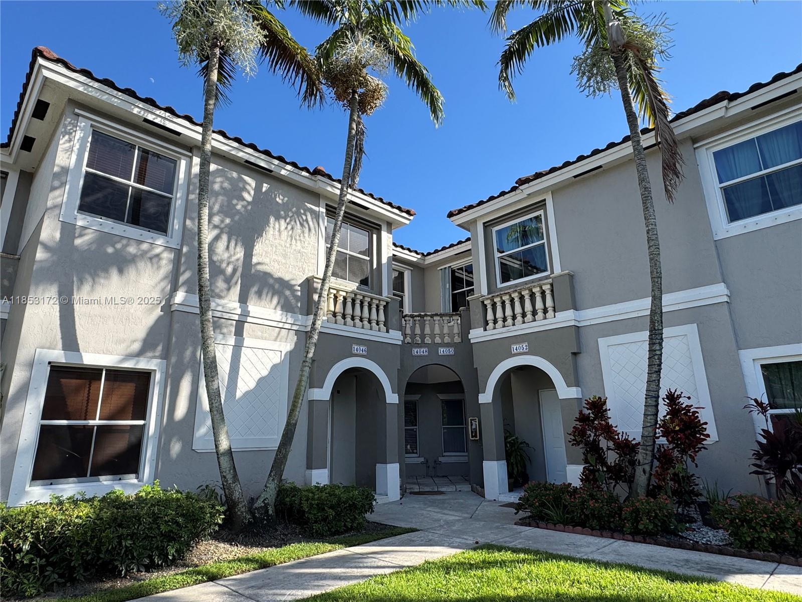 14046 Southwest 49th Street, Unit 16 Miramar, FL 33027 - Photo 21 of 22 a front view of a house with garden