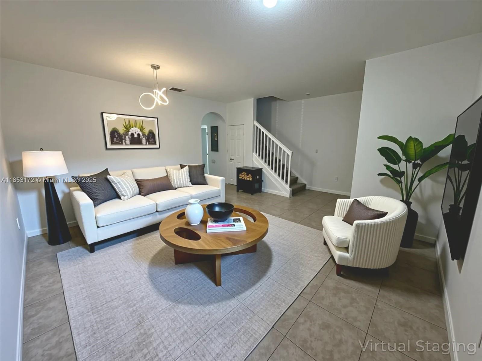 14046 Southwest 49th Street, Unit 16 Miramar, FL 33027 - Photo 3 of 22 a living room with furniture and a potted plant