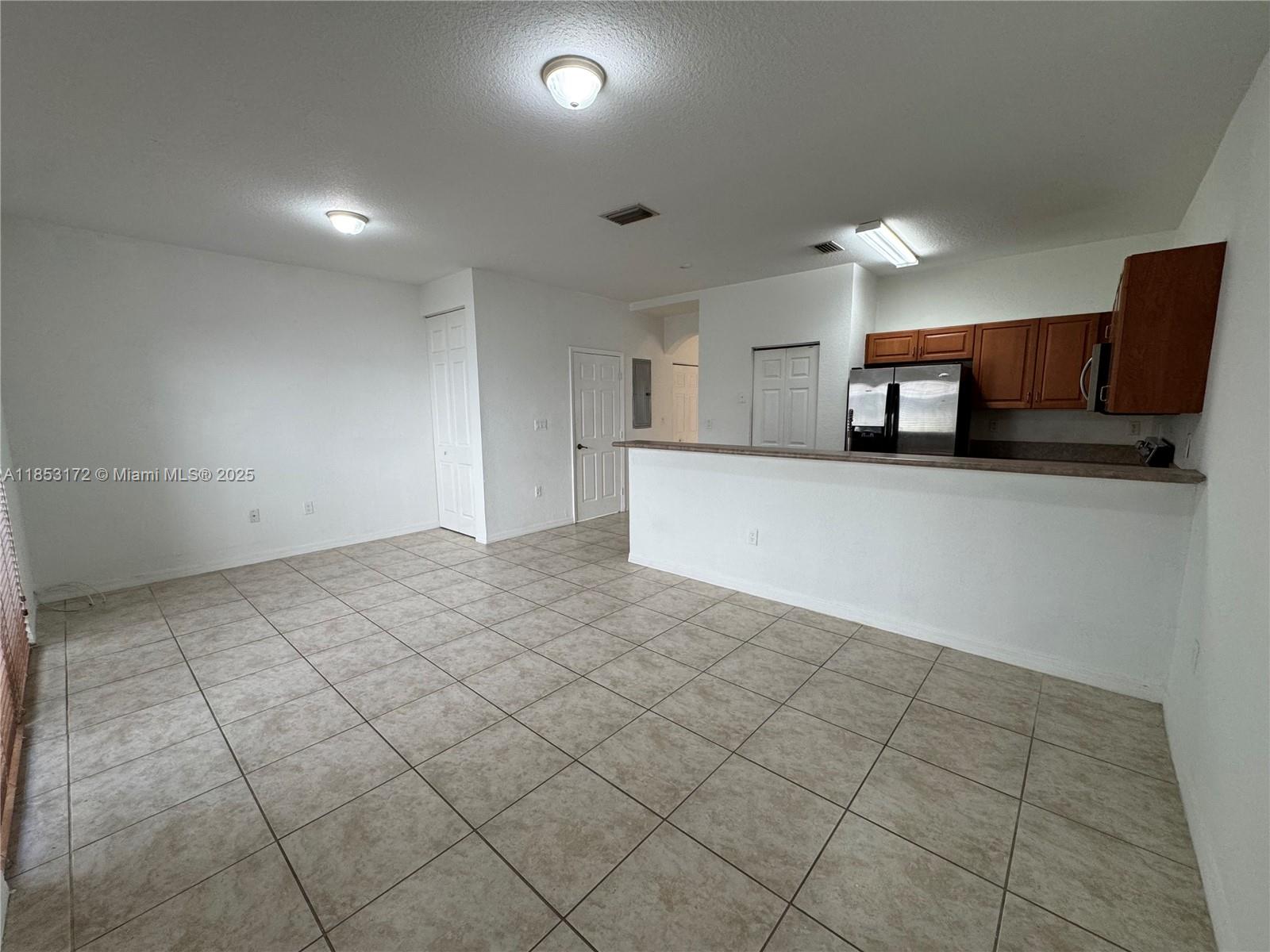 14046 Southwest 49th Street, Unit 16 Miramar, FL 33027 - Photo 4 of 22 a view of a kitchen with a sink and a refrigerator