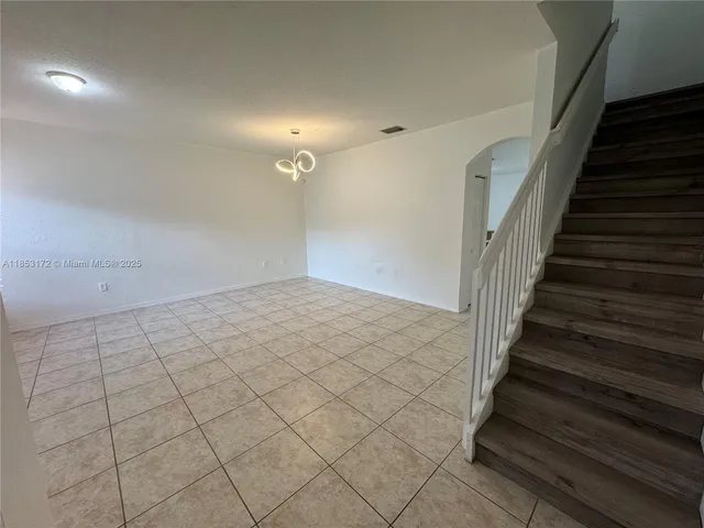 an empty room with windows and entrance