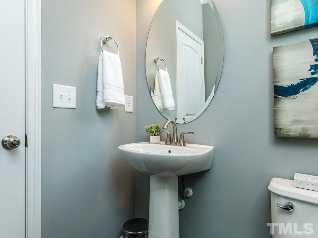 204 Kentigern Drive, Unit 34 Raleigh, NC 27606 - Photo 12 of 33 a bathroom with a sink and a mirror