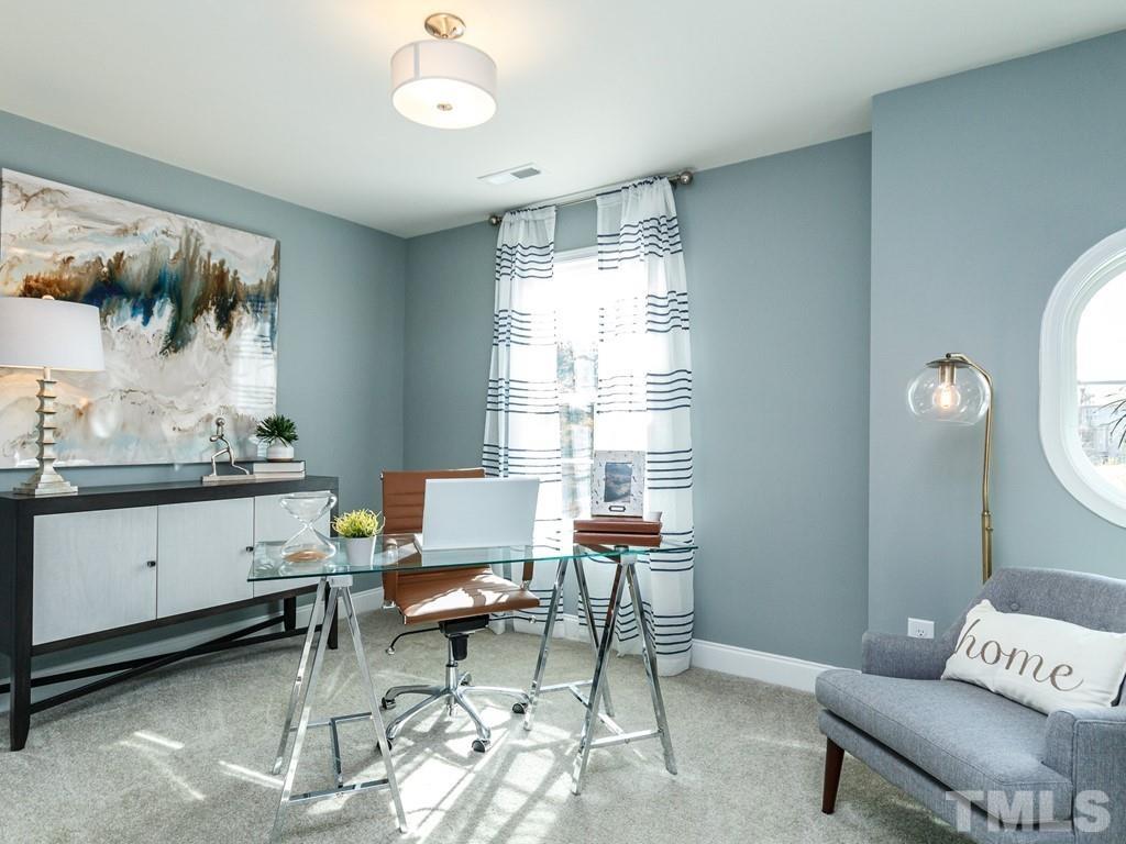 204 Kentigern Drive, Unit 34 Raleigh, NC 27606 - Photo 13 of 33 a living room with furniture and a window