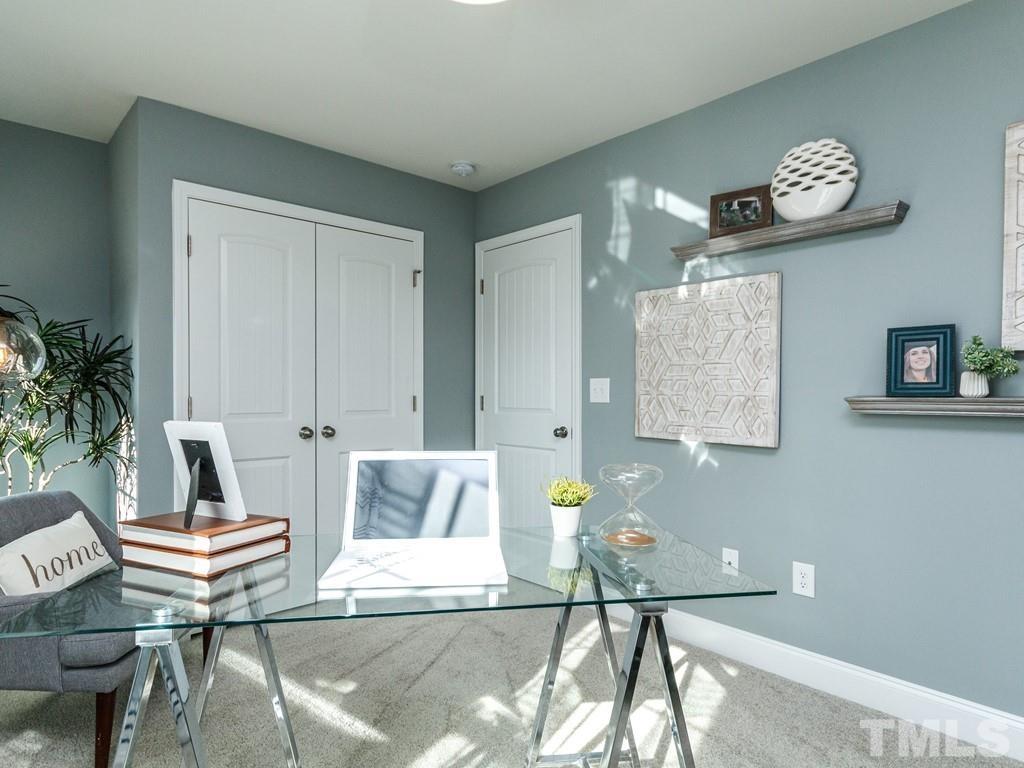 204 Kentigern Drive, Unit 34 Raleigh, NC 27606 - Photo 14 of 33 a living room with a table and chairs