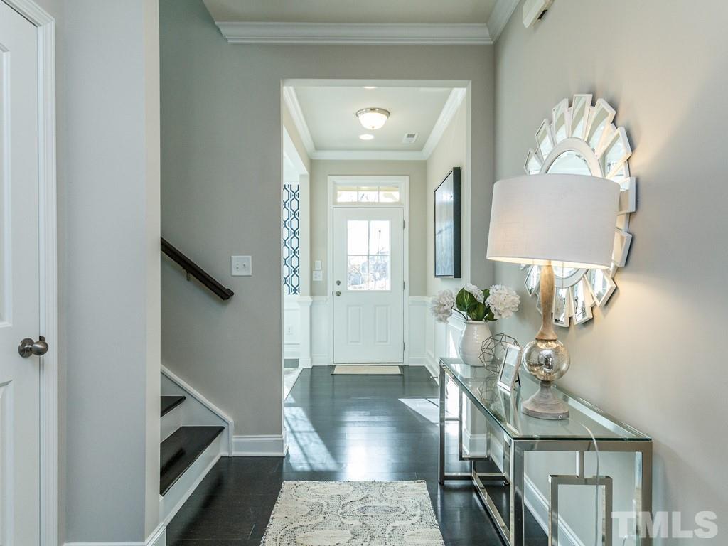 204 Kentigern Drive, Unit 34 Raleigh, NC 27606 - Photo 20 of 33 a view of a hallway with furniture and wooden floor