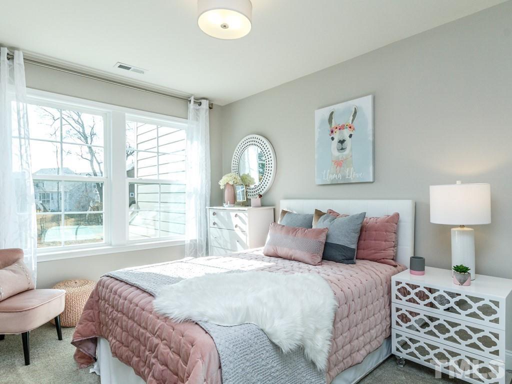 204 Kentigern Drive, Unit 34 Raleigh, NC 27606 - Photo 2 of 33 a bedroom with a bed and a lamp next to a window