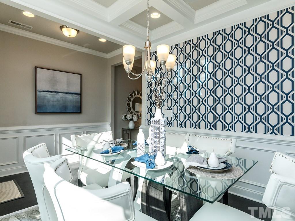 204 Kentigern Drive, Unit 34 Raleigh, NC 27606 - Photo 22 of 33 a dining room with furniture and wooden floor