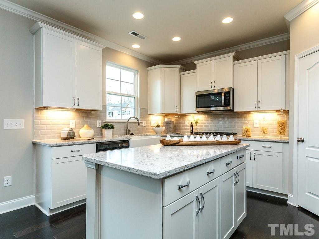 204 Kentigern Drive, Unit 34 Raleigh, NC 27606 - Photo 25 of 33 a kitchen with stainless steel appliances granite countertop a sink stove and cabinets