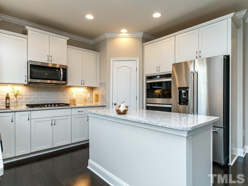 204 Kentigern Drive, Unit 34 Raleigh, NC 27606 - Photo 26 of 33 a kitchen with stainless steel appliances a refrigerator stove microwave and sink