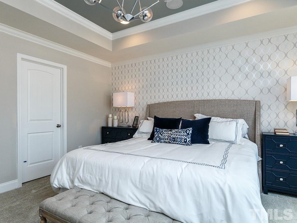 204 Kentigern Drive, Unit 34 Raleigh, NC 27606 - Photo 28 of 33 a large bed sitting in a bedroom and lamp