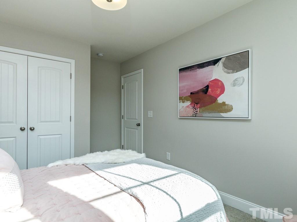 204 Kentigern Drive, Unit 34 Raleigh, NC 27606 - Photo 3 of 33 a bedroom with a bed and a painting on the wall