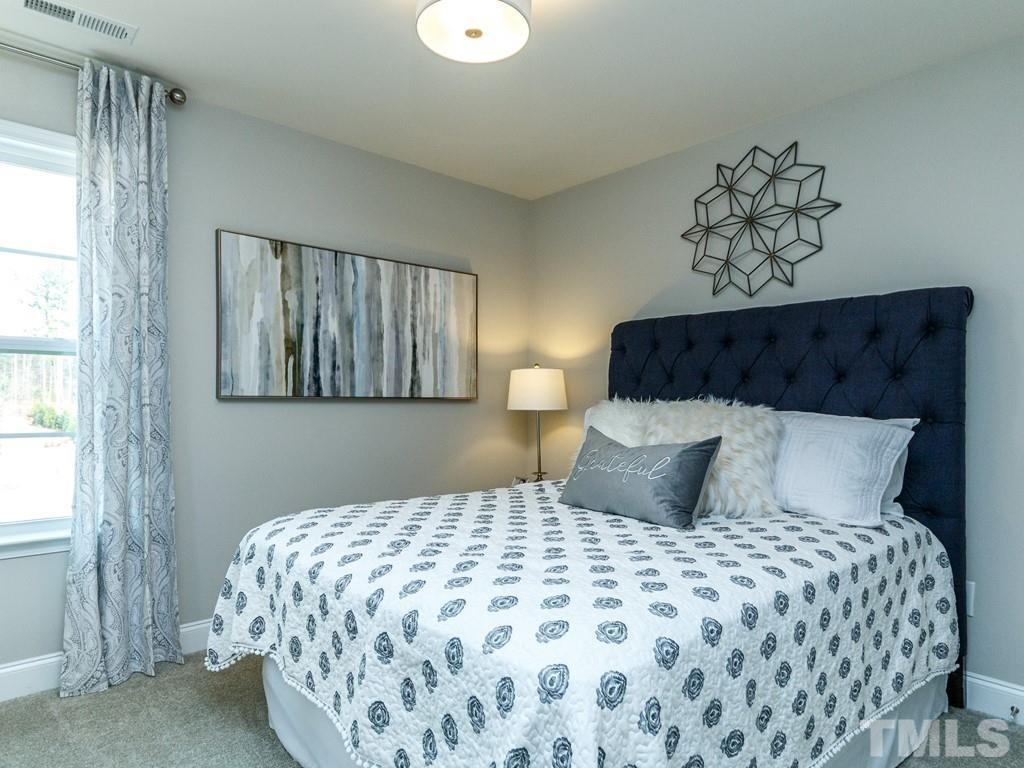 204 Kentigern Drive, Unit 34 Raleigh, NC 27606 - Photo 5 of 33 a bedroom with a large bed and a window