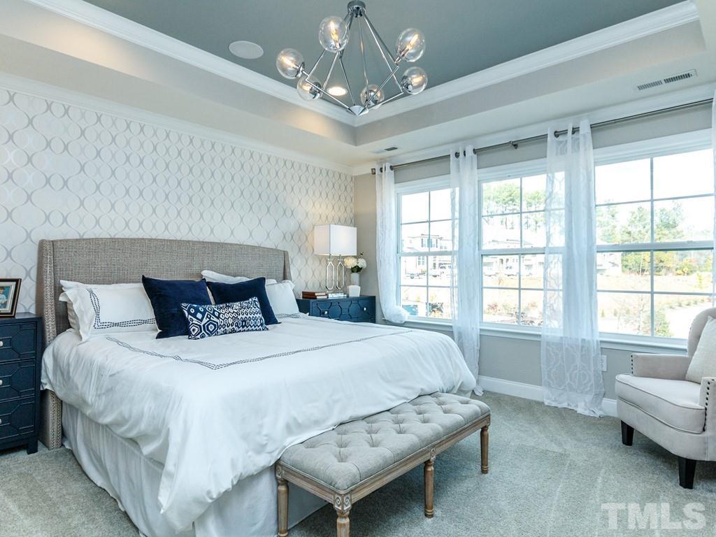 204 Kentigern Drive, Unit 34 Raleigh, NC 27606 - Photo 7 of 33 a spacious bedroom with a bed and a couch