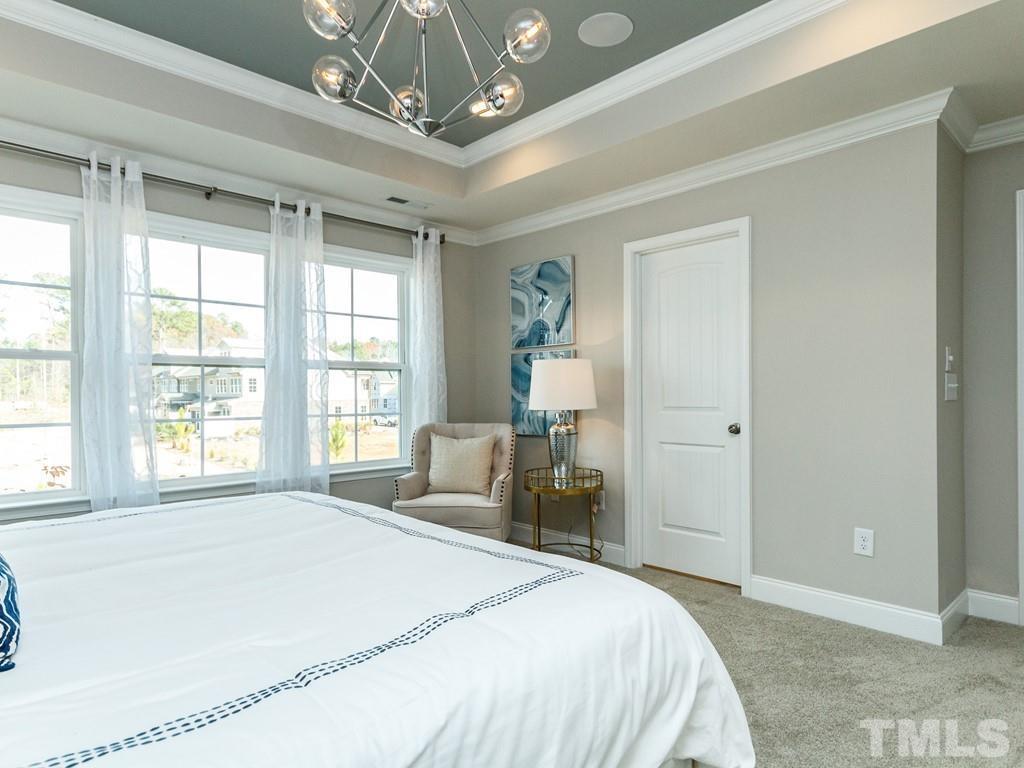 204 Kentigern Drive, Unit 34 Raleigh, NC 27606 - Photo 8 of 33 a spacious bedroom with a bed and a large window