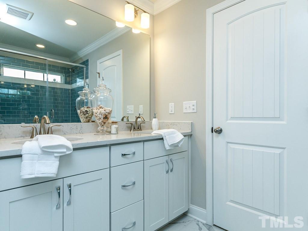 204 Kentigern Drive, Unit 34 Raleigh, NC 27606 - Photo 9 of 33 a bathroom with a double vanity sink and mirror