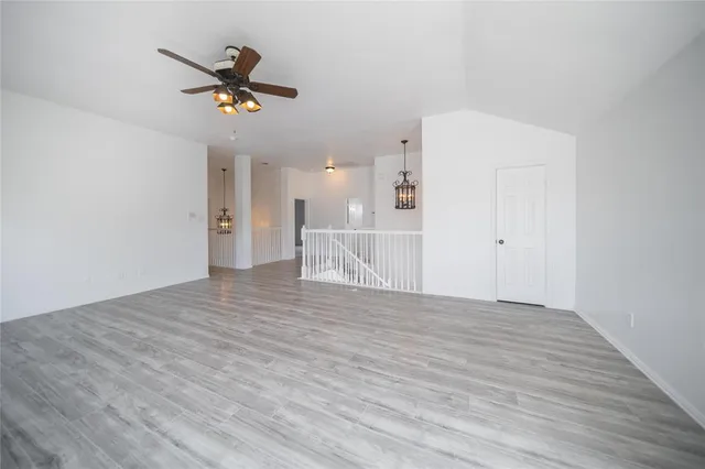 a view of an empty room and wooden floor