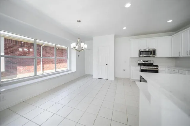 a view of a kitchen with microwave and cabinets