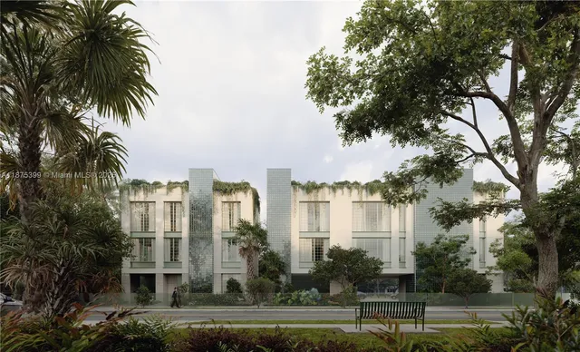 a front view of a residential apartment building with a yard and palm trees