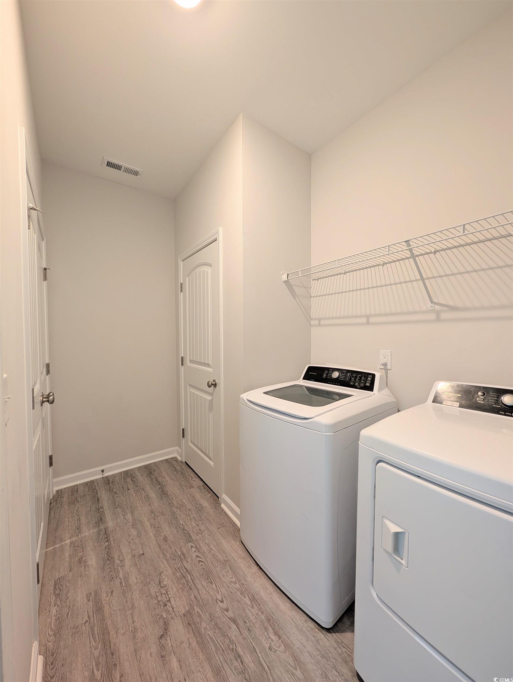 351 Lakota Loop Longs, SC 29568 - Photo 22 of 31 Washroom featuring light wood-style flooring and washing machine and clothes dryer