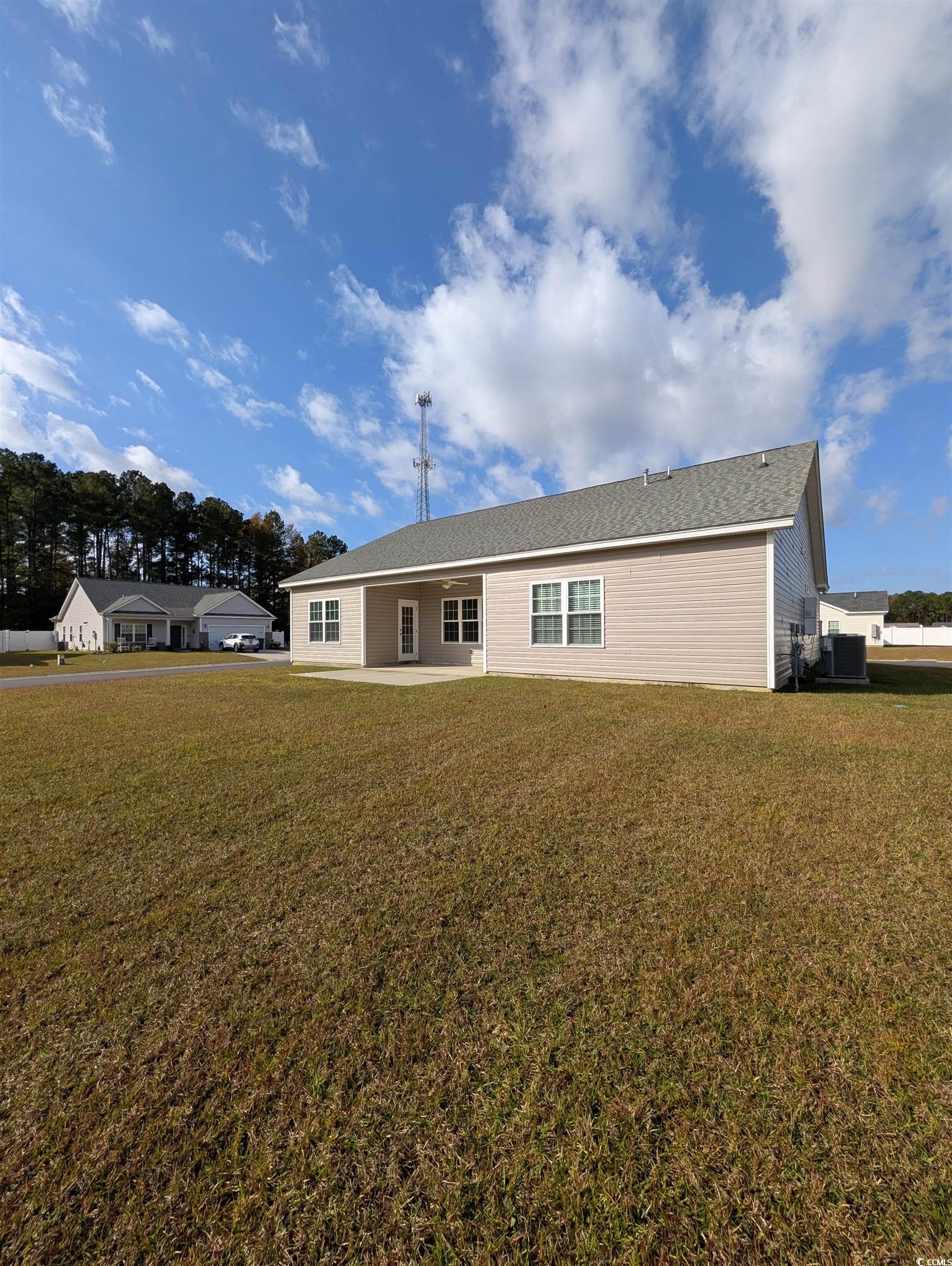 351 Lakota Loop Longs, SC 29568 - Photo 26 of 31 Rear view of house with a patio and a lawn