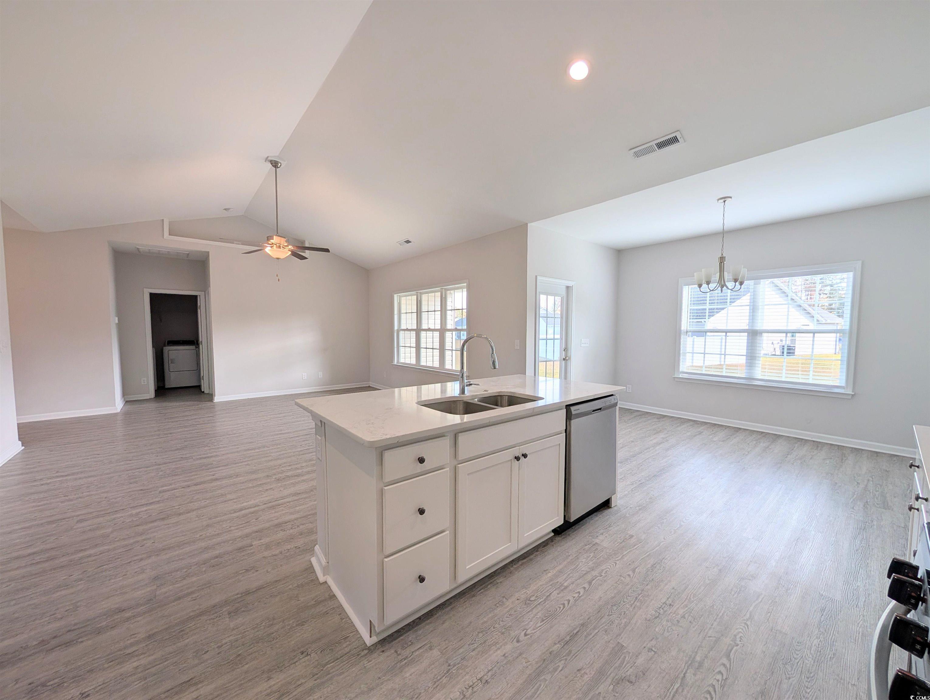 351 Lakota Loop Longs, SC 29568 - Photo 31 of 31 Kitchen with open floor plan, white cabinets, an island with sink, light wood-style floors, and vaulted ceiling
