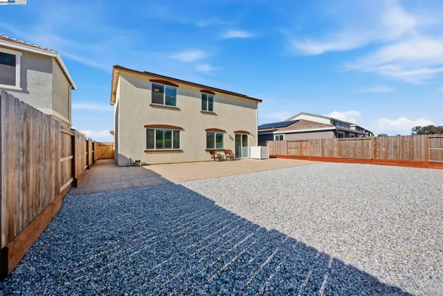 an aerial view of a house with a yard basket ball court and outdoor seating