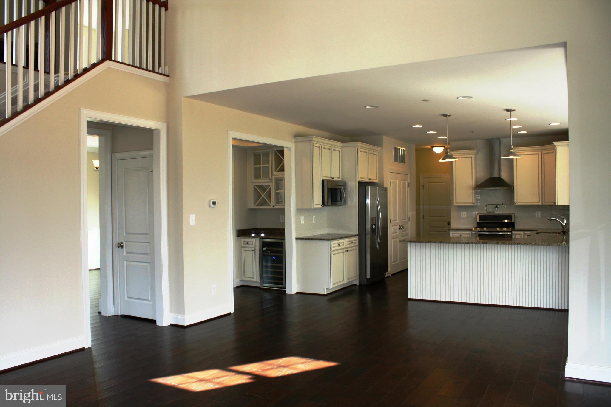 1735 Laurel Brook Road Fallston, MD 21047 - Photo 8 of 20 a kitchen with stainless steel appliances kitchen island granite countertop a refrigerator a stove and a sink with wooden floor
