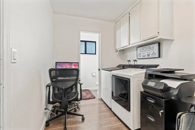 a view of a storage and utility room with washer and dryer