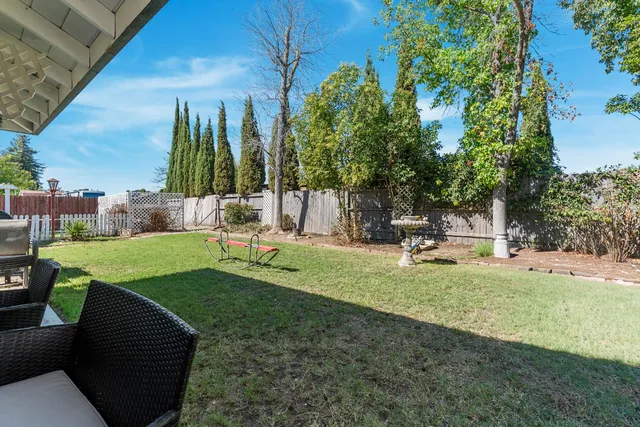 a view of backyard with a table and chairs