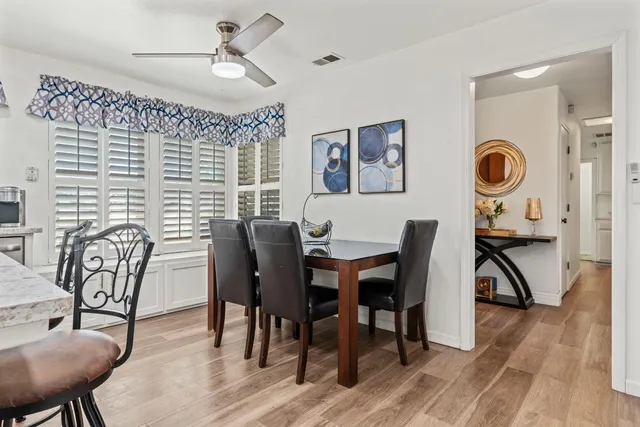 a view of a dining room with furniture and wooden floor