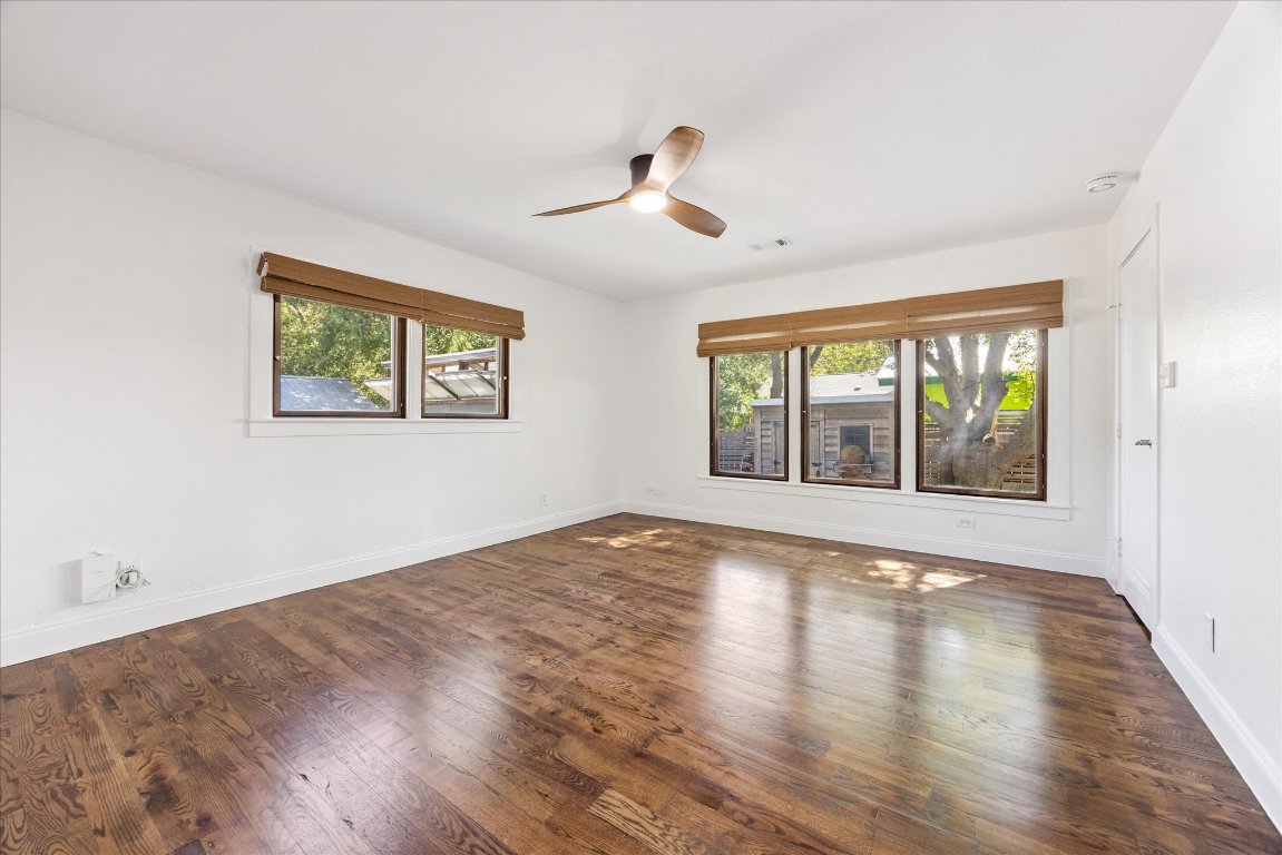 1106 Fairmount Avenue Austin, TX 78704 - Photo 11 of 25 a view of an empty room with wooden floor and a window